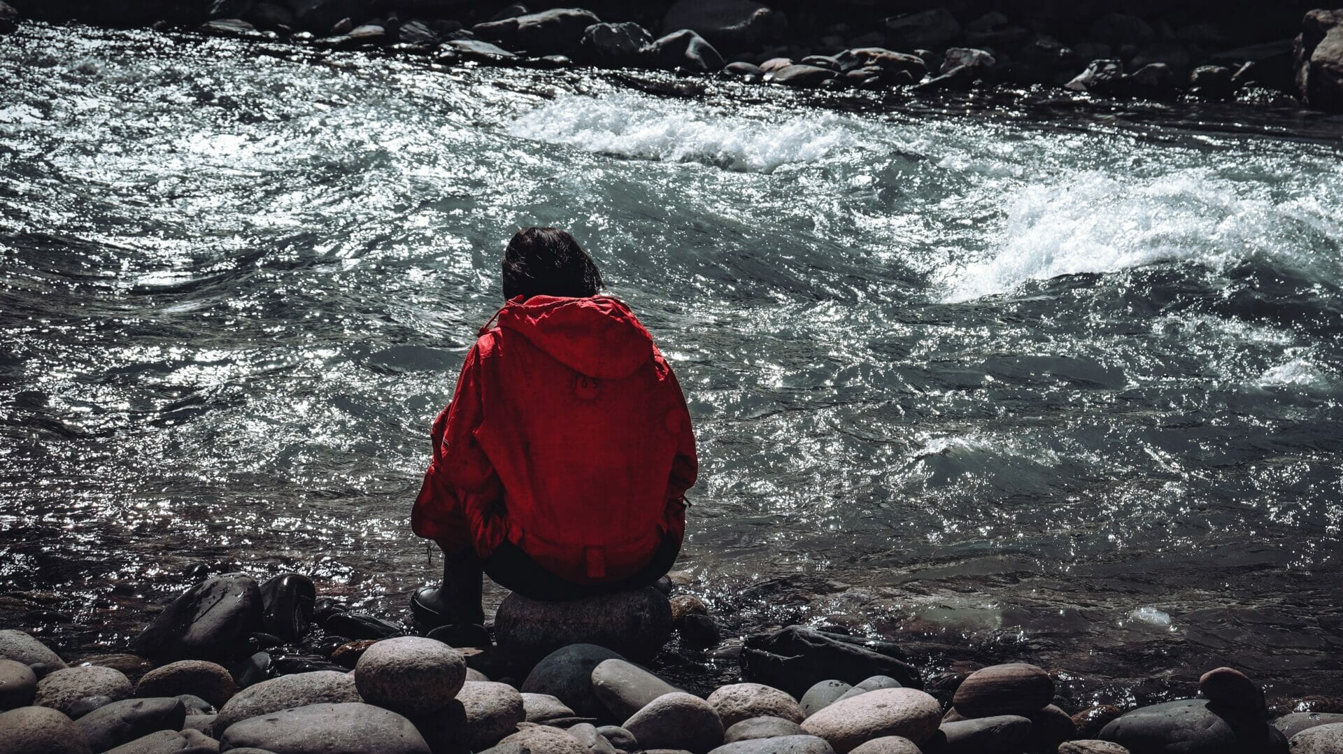 A man, alone, sitting by the sea, with his back to the camera. Representative image used to indicate loneliness, mental ill health.